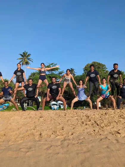 The full view of our human pyramid on the beach. This acro yoga challenge was a highlight, filled with teamwork, support, and a lot of laughter.