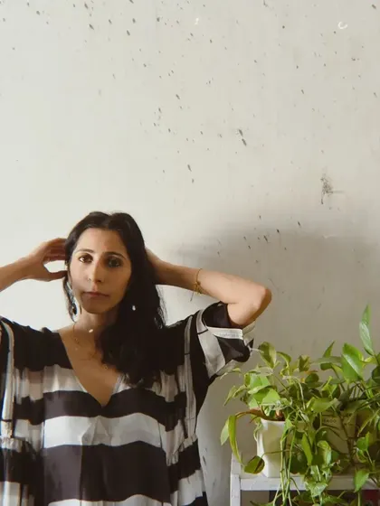 A portrait for House of Wandering Silk that incorporates natural elements, with plants framing the model.