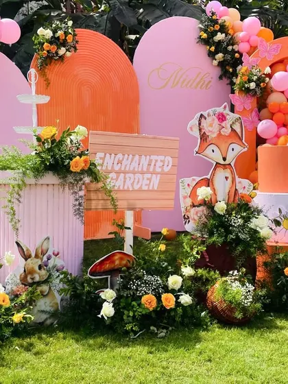 A closer look at the enchanted garden dessert table, with a fox-themed cake, mushroom props, and beautiful floral arrangements.