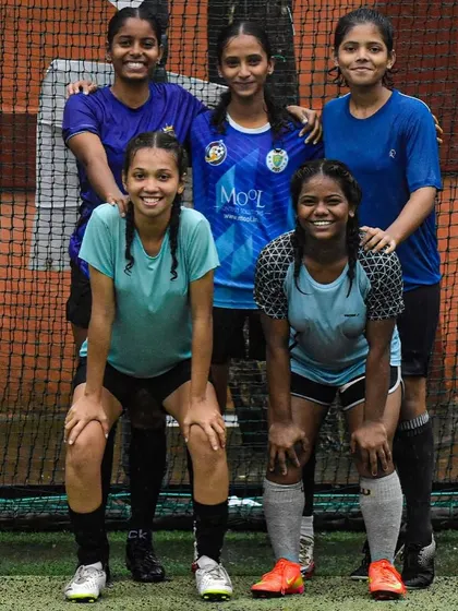 The girls' team posing for a photo during the Inter SG5 Cup. The smiles and camaraderie show the strong bonds within the team.