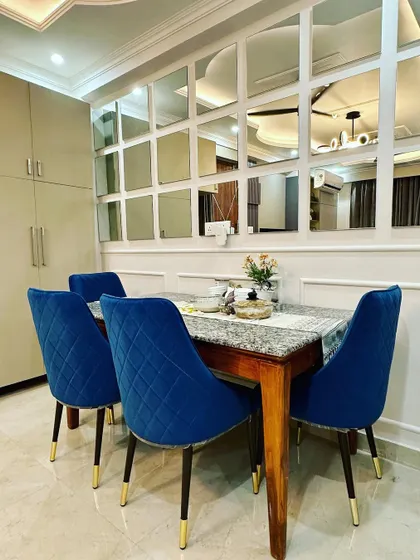 This angle shows the dining set in relation to the nearby storage unit, demonstrating a cohesive and functional room layout.