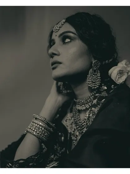 Another perspective of this vintage bridal look, with a white rose tucked into her hair. The contrast of the soft flower against the heavy silver jewelry creates a beautiful balance.