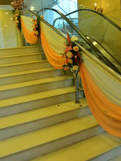 We also decorate other parts of the venue, like staircases and escalators, with drapes and flowers to maintain the theme throughout.