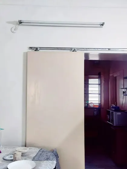 This before-and-after view of the dining and kitchen area highlights the power of opening up spaces. We replaced a solid wall and sliding door with a large opening and integrated shelving, creating a visual connection that makes the entire ground floor feel more spacious and sociable.