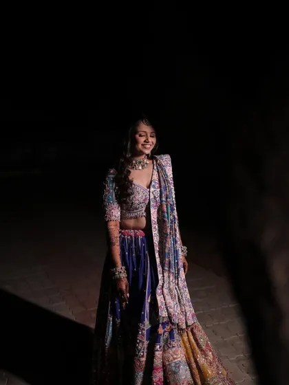 The bride, laughing joyfully during her Dandiya night.