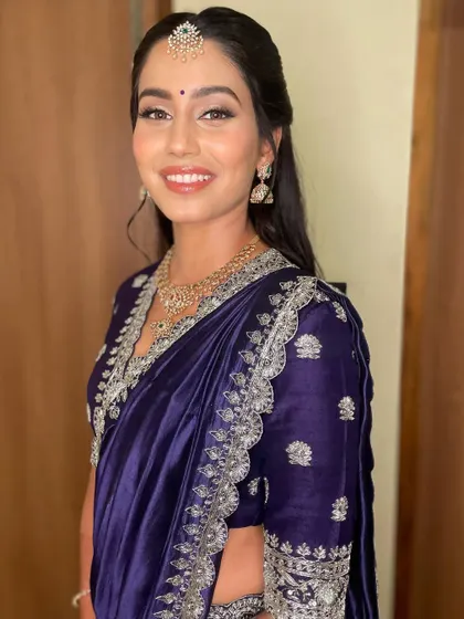 Another beautiful shot of this navy blue reception look, highlighting the elegant makeup and jewelry.
