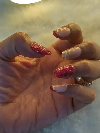 I love giving the classic French a twist. Here, I used a shimmery red and gold polish for the tips, creating a bold and festive look that’s perfect for a celebration.