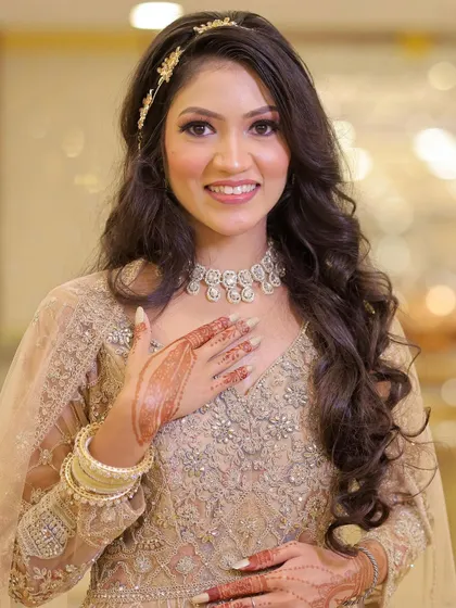 A happy, smiling portrait of the bride. Her makeup is natural and radiant, letting her own beauty shine through.