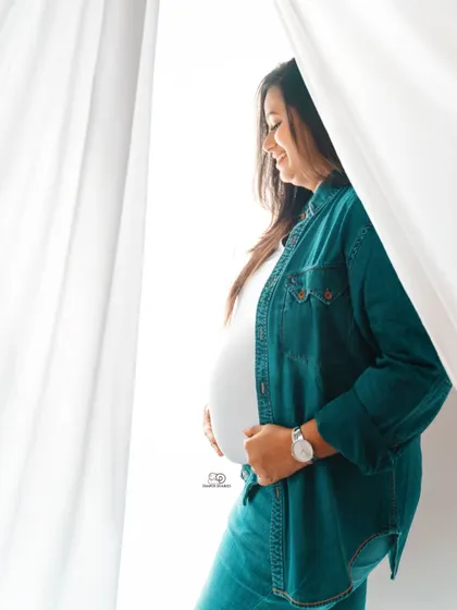 This relaxed portrait in a denim shirt and jeans shows a casual and comfortable side of maternity style. Perfect for an at-home or simple studio session.