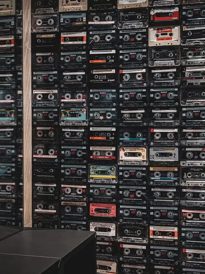 As a nod to the creative and analogue spirit of the client's vision, we designed a feature wall composed entirely of vintage cassette tapes. This unique installation serves as a powerful visual and nostalgic anchor within the modern, industrial workspace.