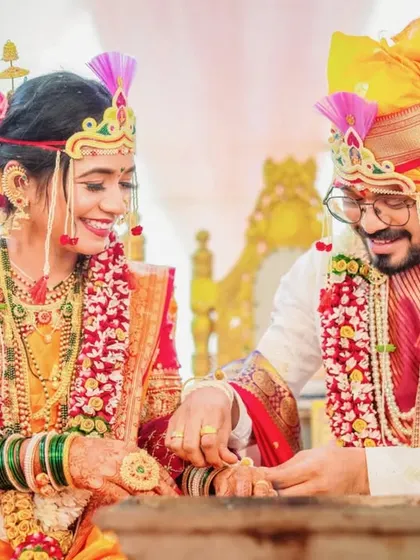 A happy, candid moment between the bride and groom as they participate in a post-wedding game or ritual.