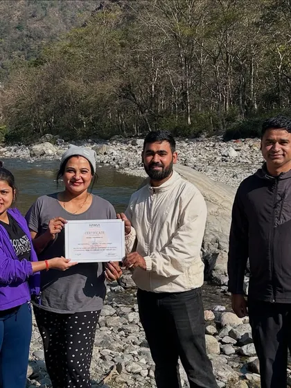 Another happy participant is recognized for her dedication during our 5-day yoga escape. The natural setting by the river makes these moments of acknowledgment even more special and memorable.