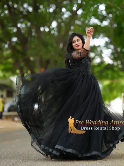 A dynamic twirl in the black ball gown, showcasing the volume and flow of the tulle skirt.