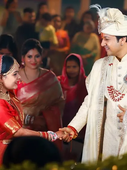 The bride and groom sharing a look as they hold hands. This candid moment captures the sweet connection and partnership between them.