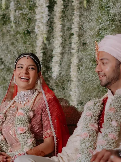 A candid, joyful moment between the bride and groom during the pheras. Her makeup looks fresh and natural, even in the midst of the ceremony.