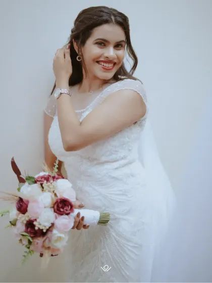 A happy Christian bride holding her bouquet, her smile radiating pure joy.