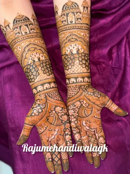 A grand design with palace architecture and peacocks on the arms, and intricate patterns on the palms.