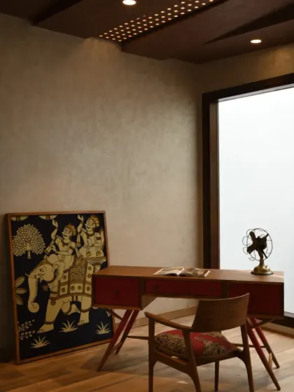Adjacent to the second-floor lobby in Ashraya Residence lies this quiet multipurpose room, currently used as a library. The decor is intentionally minimal, with wooden flooring and curated artwork lending the space a sense of calm.