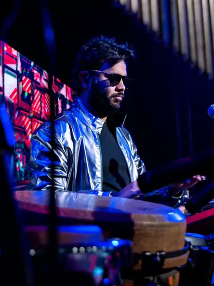 A moody shot from a performance at the IIMA Chaos festival. The lighting and my focus on the electronic pads highlight the modern, fusion aspect of my music.