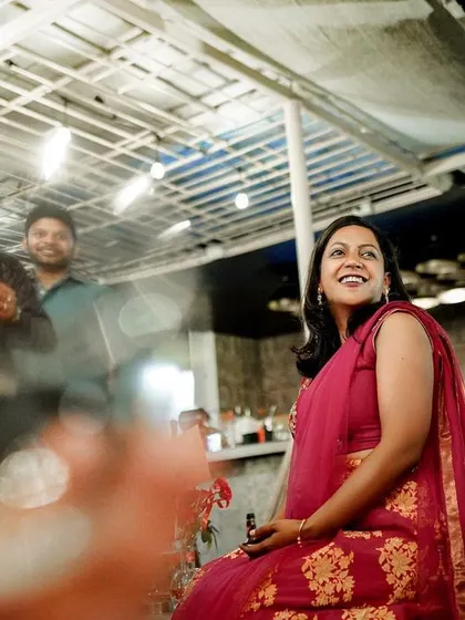 A candid moment of a guest enjoying the reception, captured with a creative, blurry foreground.