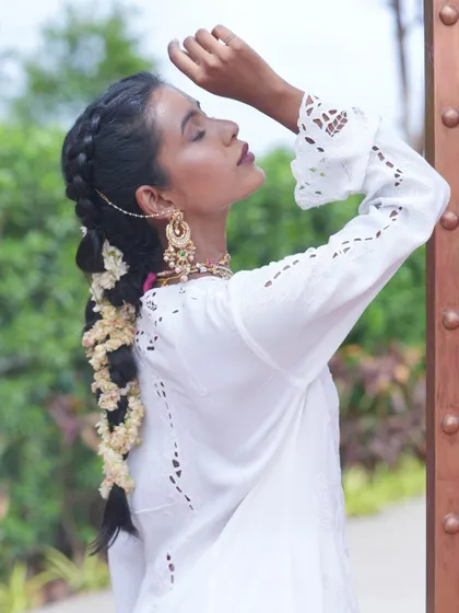 Get ready for the wedding season with our premium hair extensions. This model showcases a beautiful braided hairstyle, enhanced with extensions for extra length and volume.