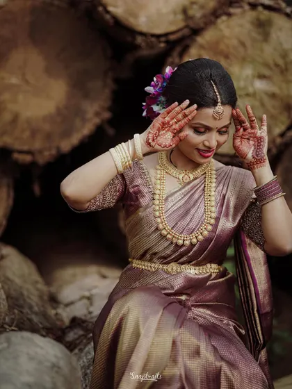 A playful and happy moment, with the bride striking a pose that shows off her beautiful henna and joyful spirit.