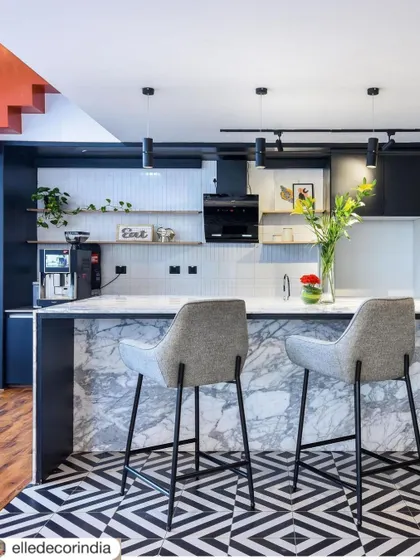 Our pantry design for the Venus Communiti coworking space, shared by Elle Decor India. The bold flooring and marble island were noted for their stylish and functional appeal.