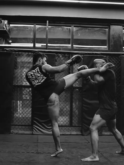 The beauty of combat is in its precision. A perfectly timed kick during a kickboxing sparring session, capturing the art of striking.