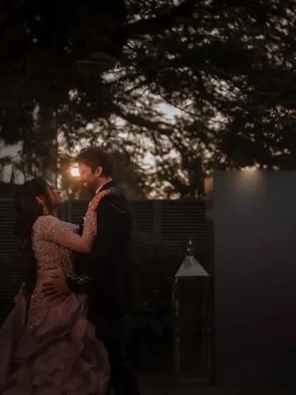 A quiet dance at dusk. The soft, ambient light creates a romantic and slightly mysterious mood for this beautiful couple's portrait.
