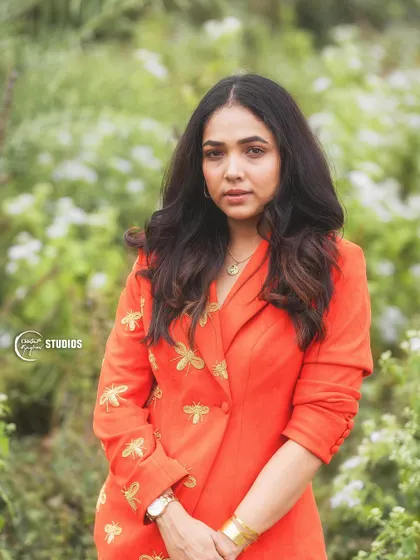 A portrait shot showing how the bold orange color complements the client's features.