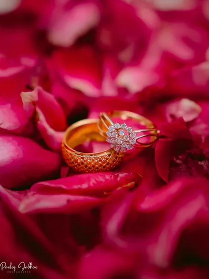 The promise, captured forever. This close-up of Ojasi and Rutvik's engagement rings nestled in rose petals highlights my focus on the small, significant details that tell your larger love story.