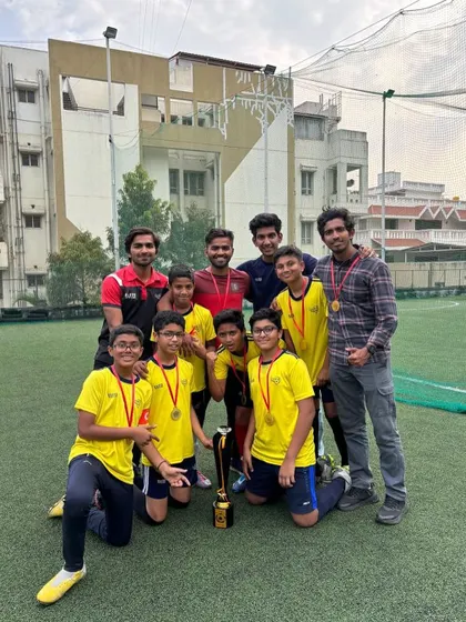 The full U13 squad and coaches celebrating their BEL Cup victory.