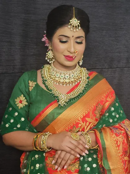 The bride's eyes are closed, highlighting the soft and blended eyeshadow. The makeup is designed to look elegant and timeless.