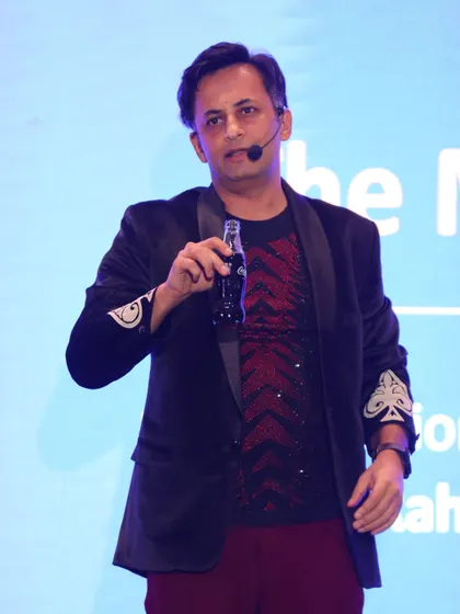 A moment of brand integration, magically producing a bottle of Coca-Cola during the show. Small touches like this can be customized to fit any event sponsor.