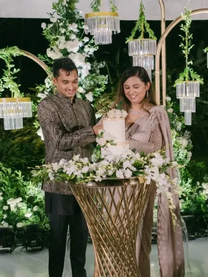 The cake cutting ceremony is a classic moment. We designed this elegant cake station with a minimalist white floral backdrop, ensuring the focus remained on the couple's happy celebration.