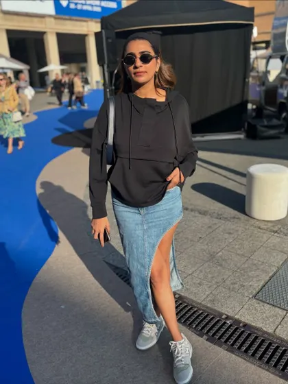 A casual but edgy look. I love this asymmetrical denim skirt paired with a simple black hoodie and sneakers for a cool, off-duty vibe.