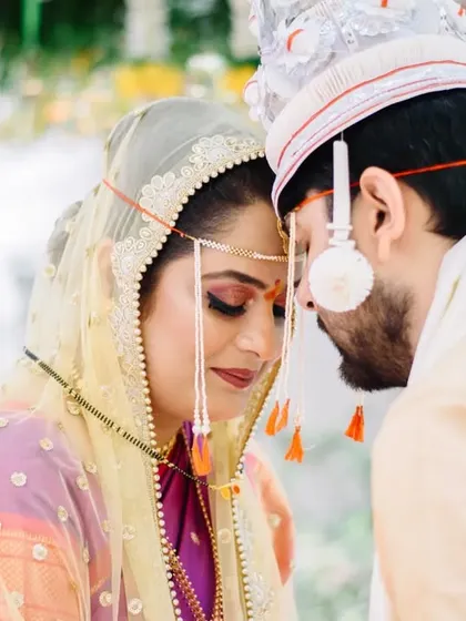 A moment of quiet connection during the wedding pheras. Prerna and Abhiroop's foreheads touching is a powerful, intimate gesture that speaks volumes about their bond during their Marathi Bengali wedding.
