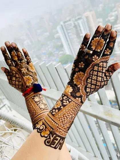 The back of the hands for the baby shower mehendi, with beautiful floral and jaal patterns.