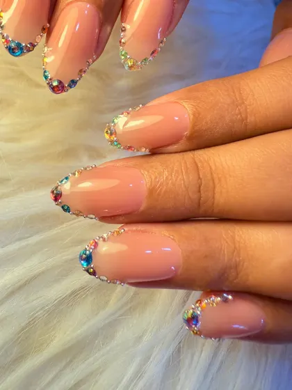 For a touch of sparkle, we created this beautiful design featuring a rainbow of tiny crystals lining the cuticle. It's a simple yet glamorous way to add color and shine to a neutral manicure.