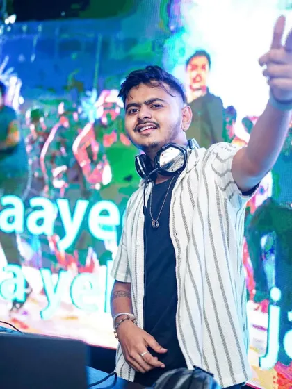 The visuals behind me say 'Taare Zameen Par' while I point to the crowd. As a VDJ, I use iconic Bollywood visuals to connect with the audience on another level.