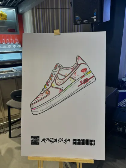 A branded art canvas on an easel, ready for guest interaction at the Broadway event. This is a key part of our interactive experience, inviting attendees to co-create with us.