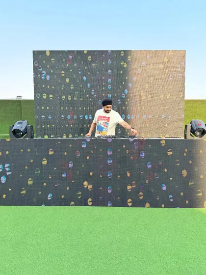 Setting up for a vibrant Holi party. This outdoor setup includes a large LED wall and a professional DJ console, perfect for creating a festive atmosphere with colorful visuals and music.