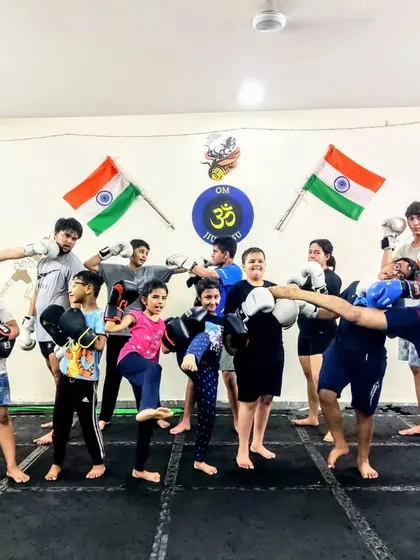 This is what enjoying the process looks like. I am executing a controlled high kick while the kids show off their boxing stances, capturing the energy and fun we have in every class.