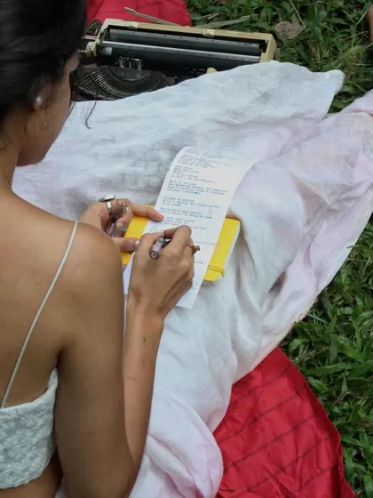 Signing a freshly typed poem. This act of putting my name to the words is a final, personal touch, a promise of authenticity and a seal of the connection we just shared.