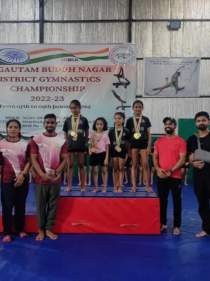 Our gymnasts and coaches on the podium. Teamwork makes the dream work.