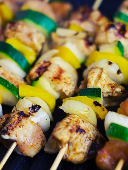 Colorful chicken and vegetable skewers sizzling on the barbecue. A live barbecue is a perfect addition to winter parties, filling the air with an irresistible aroma and serving up tender, mouthwatering bites.