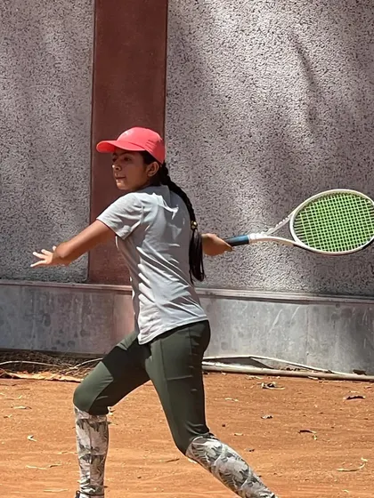 A young girl executing a powerful backhand. We focus on developing strong fundamentals for all our players.
