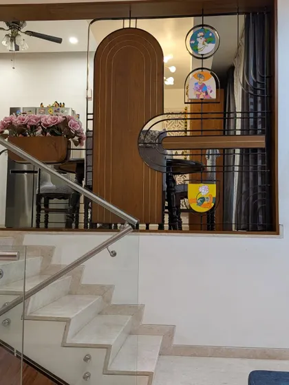 A custom-designed partition separating the dining space, featuring wood, metal, and hand-painted art panels.