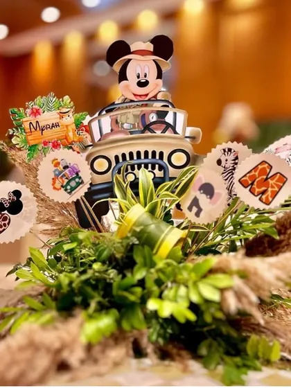 Another angle of the unique safari jeep centerpiece. The combination of natural textures like pampas grass and fun character elements perfectly captures the spirit of a wild celebration.