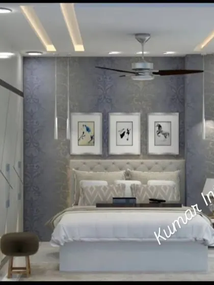 This bedroom features a textured blue accent wall behind the bed, complemented by a tufted headboard and modern pendant lights.